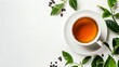 White cup of tea on white background with green tea leaves and coffee beans