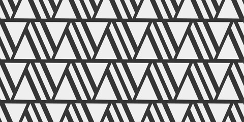 Wall Mural - Black and white pattern of triangles. Seamless pattern of white triangles.