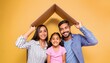 © Marko - Happy multiethnic family with child holding cardboard roof