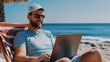 © Exnoi - Young professional attending a video call on a sunny beach, laptop in hand
