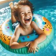 overjoyed laughing smiling exited child in swimming pool floating on swimming ring