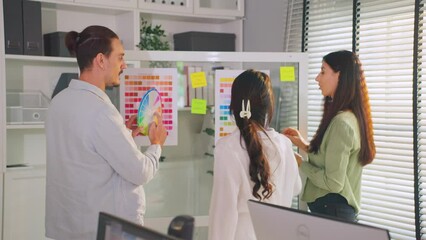 Wall Mural - Young multi-ethnic businessman and businesswoman working in office. 