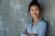 © Twinny B Studio - Confident and elegant businesswoman in blue, long hair styled in bun, cheerful expression, textured office backdrop