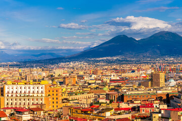 Wall Mural - urban view on a Naples city with houses buildings and mount Vesuveus with amazing cloudy sky on background of landscape