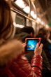 © Marc Elias - An individual playing on a portable gaming device while commuting on public transportation.