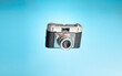 Vintage camera on a light blue background. Photography day concept