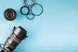 Photo camera, lenses and photographer's equipment on a blue background with space for text. Photographer's day concept
