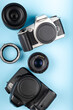 Flat lay of equipment for professional photographer on blue background. Photographer's Day Concept