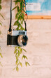 Old black camera hanging on the wall.