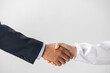 Closeup of a business handshake, isolated on white background.