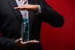 Close-up of businessman hand holding water bottle isolate on blue background.