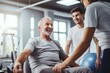 Happy elderly man engaging with personal trainers during a workout session in a gym