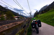Touring cyclist by mountain railway in spring