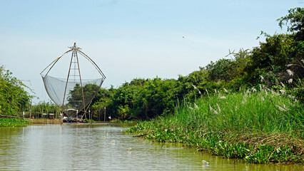 Wall Mural - fisherman boat on the tonle sap river in cambodia