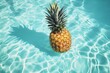 A single pineapple floats on a crystal clear swimming pool, with sunlight dancing on the water