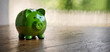Green piggy bank concept for sustainable finance or environmentally friendly savings