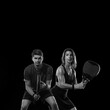 Padel Tennis Player with Racket in Hand. Paddle tenis, on a black background. Download in high resolution.