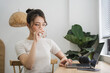 © Q88 - Portrait of asian girl working at home