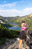 Fototapeta  - Adventure woman hiker on trial in Tatra Mountains in Poland. Back view.