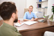 Female caucasian gynecologist listening partial couple at consultation in clinic