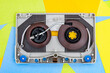 Top view of Turntable arm on old vintage retro audio tape cassettes with a background of multicolored paper sticky notes