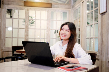 Poster - Portrait of a businesswoman using her laptop while working