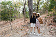 © itchaznong - Happy LGBT Lesbian couple Travelers Hiking with Backpacks in waterfall Trail. LGBT Lesbian Couple Hikers with backpacks walks in mountains in vacation