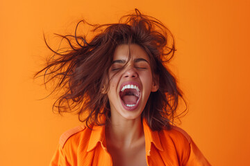 Portrait of an excited woman with an open mouth and messy hair screaming, isolated on an orange background, in the style of photo realistic photography