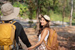 © Natee Meepian - Lovely couple lesbian woman with backpack hiking in nature. Loving LGBT romantic moment in mountains