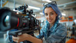 © aekkorn - Young Caucasian Female Cinematographer With Blue Hair Adjusts Camera Equipment In Modern Studio, Focusing On Creative Video Production For Advertising, Showcasing Teamwork And Artistic Skill.