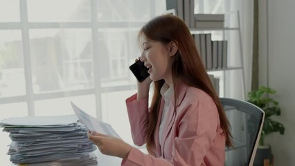 Wall Mural - a lovely employee is talking on the phone with company important client in private office, businesswoman is making a deal with manufactory via a phone, smiling of happiness with company success