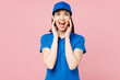 Delivery girl employee woman wear blue cap t-shirt uniform workwear work as dealer courier scream sharing hot news about sales with hands near mouth isolated on plain pink background. Service concept.