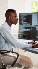 African American Coder Using Computer At Desk