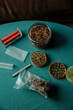 cannabis buds, grinder and tobacco on a table
