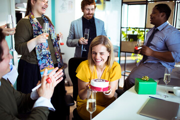 Canvas Print - Office birthday celebration with colleagues enjoying cake and champagne