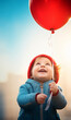 cute smiling child with a red air balloon