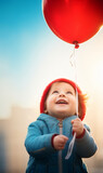 Fototapeta Zachód słońca - cute smiling child with a red air balloon
