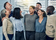 © peopleimages.com - Business people, hug and laughing in office for team building, diversity and cooperation. Employees, together and solidarity in partnership at workplace, talk and funny joke or humor in conversation