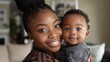 © Saim Art - African american Mom with her cute little baby boy looking at camera
