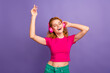 Photo of lovely cheerful glad woman wear trendy pink clothes enjoy music isolated on purple color background