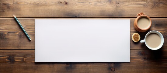 Wall Mural - From a top down perspective a wooden table is adorned with art and school supplies with a blank sheet of paper placed strategically in the center creating a copy space image