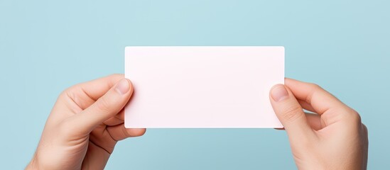 Aufkleber - A hand holds a blank card with a pastel background providing a space for copying images. Creative banner. Copyspace image