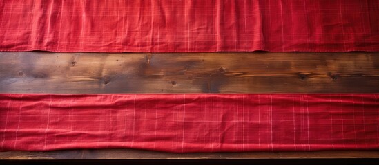 Leinwandbilder - An old wooden table is shown from above with a vibrant red tablecloth leaving an empty space for adding an image. Creative banner. Copyspace image