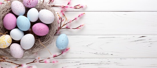 Aufkleber - A top down view of Easter eggs coated in glitter nestled in a branch nest set against a white wooden backdrop The image offers copy space for text
