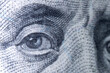 Macro image:of eye of Benjamin Franklin on the one hundred US Dollar bill.