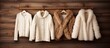 © HN Works - A wooden background with a hanger holding knitted sweaters fur jacket and coat copy space image