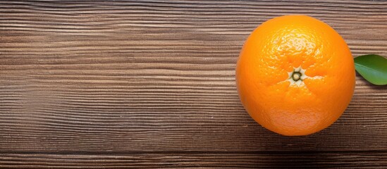 Sticker - Top view of a fresh orange placed on a textured wooden surface creating a visually appealing composition with copy space for an image