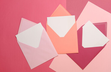 Wall Mural - Pink envelopes with white blank letters on a pink background. Creative layout