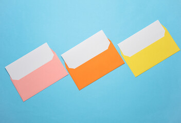 Wall Mural - Pink envelope with white blank letter and marker on a blue background. Creative layout