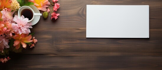 Fototapete - Top view of an office table desk adorned with various supplies such as a white blank note pad a cup a pen a pc a crumpled paper and a flower all placed on a wooden background with ample copy space im